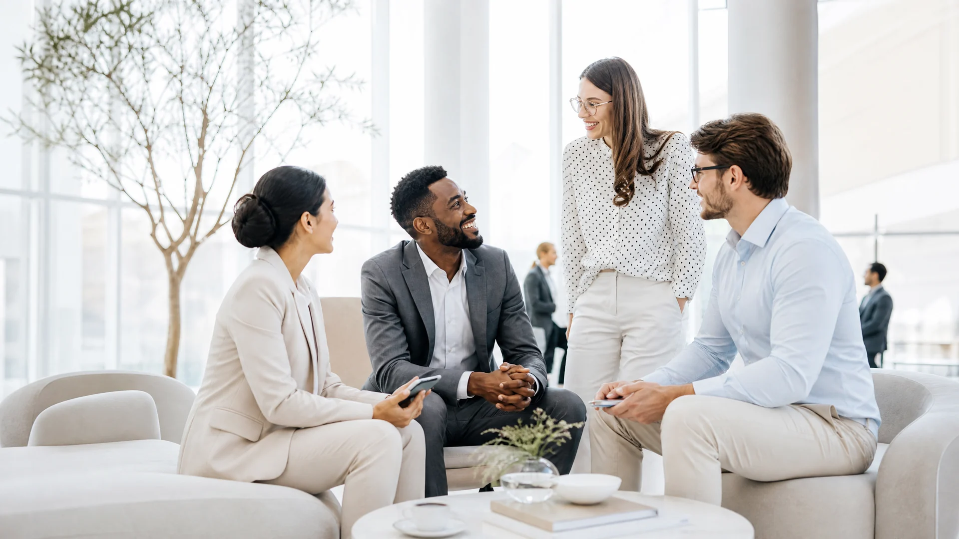 A team talking together in a bright office lounge